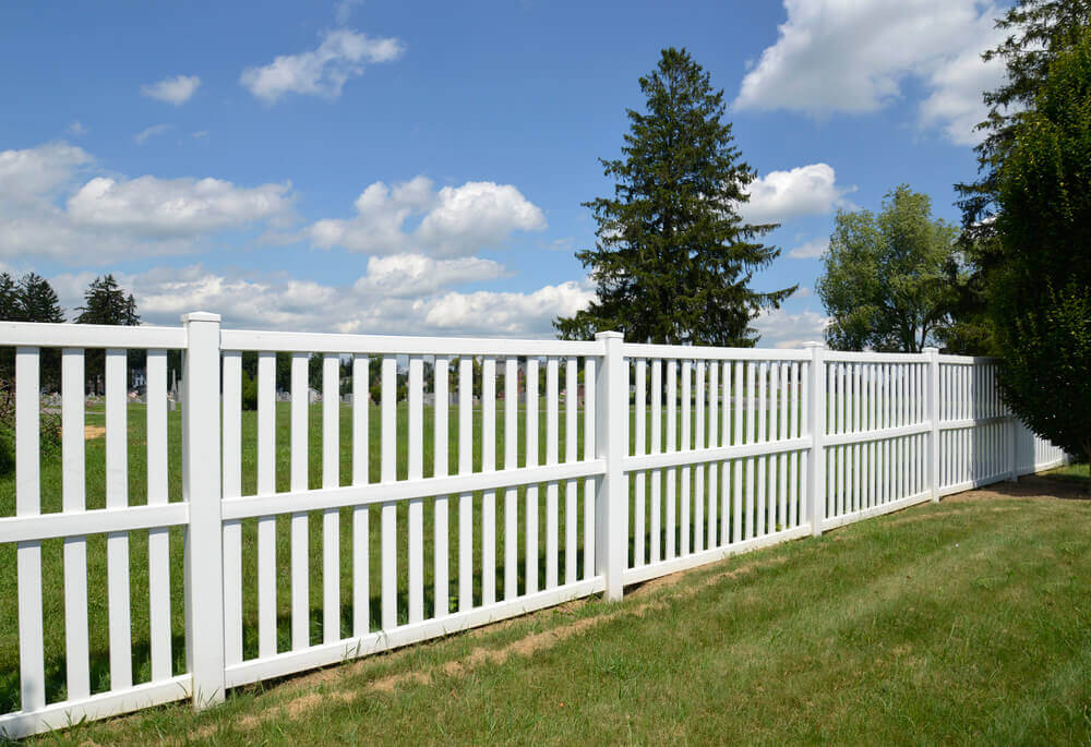 white aluminium fence in a green grassed area